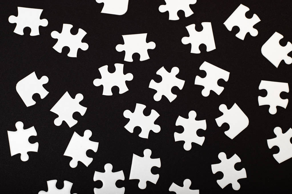 Top view white jigsaw puzzle on black background - Photo, Image