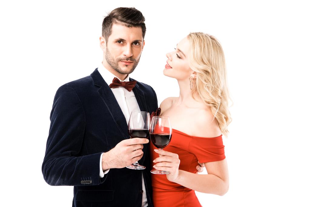 Lovely couple clinking glasses with red wine while hugging isolated on white - Photo, Image