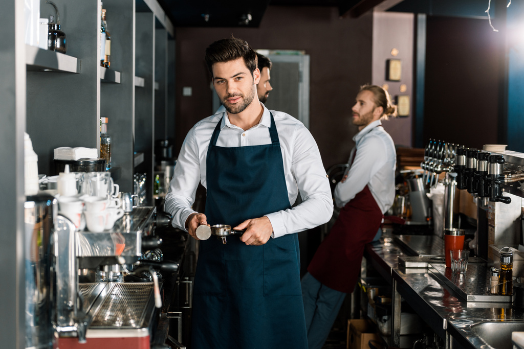 όμορφος barista στην ποδιά καφέ στο χώρο εργασίας - Φωτογραφία, εικόνα