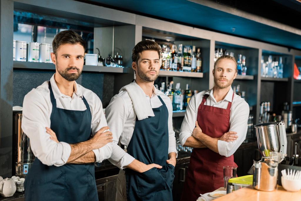 adult barmen team standing at workplace with arms crossed - Photo, Image