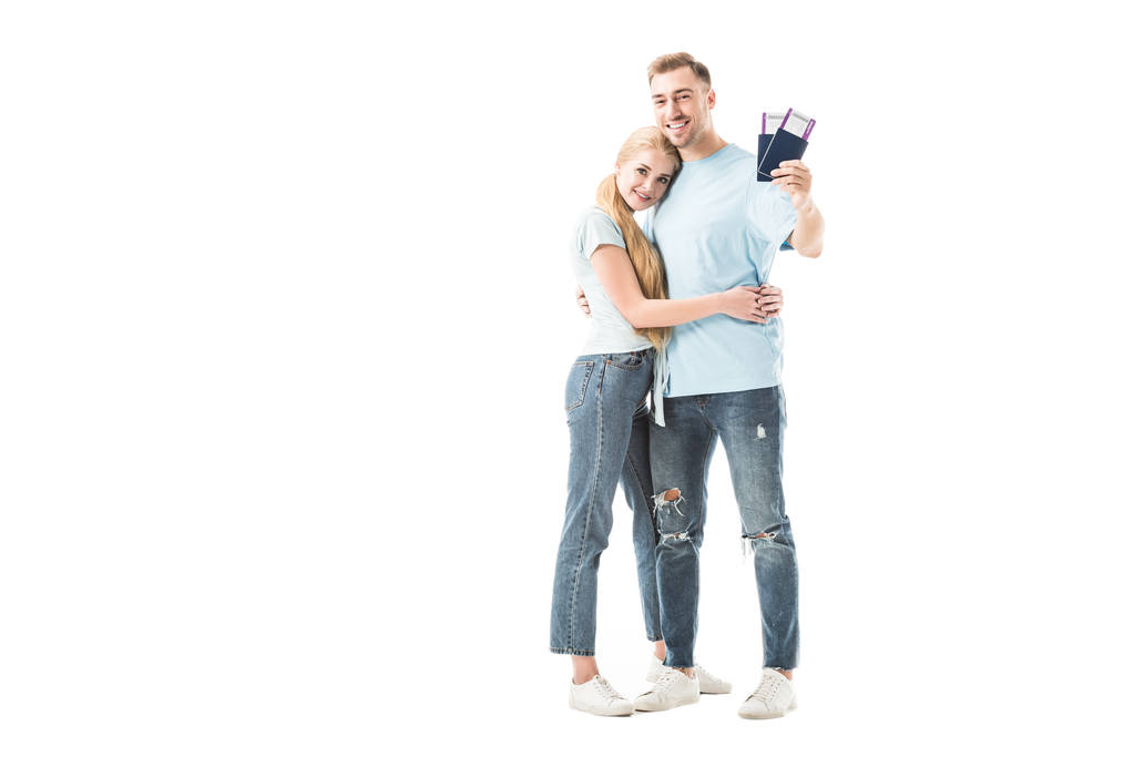 Man holding passports with tickets and hugging woman isolated on white  - Photo, Image