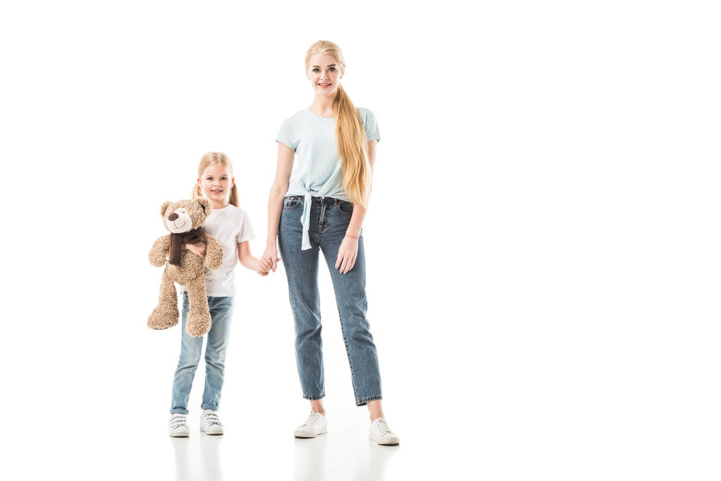 Daughter with teddy bear holding hand of mom isolated on white - Photo, Image