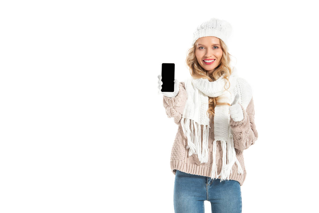 hermosa chica y mostrando el pulgar hacia arriba y teléfono inteligente con pantalla en blanco aislado en blanco
 - Foto, imagen