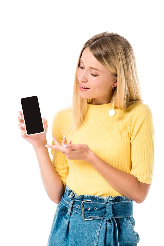 smiling young woman showing smartphone with blank screen isolated on white - Photo, Image