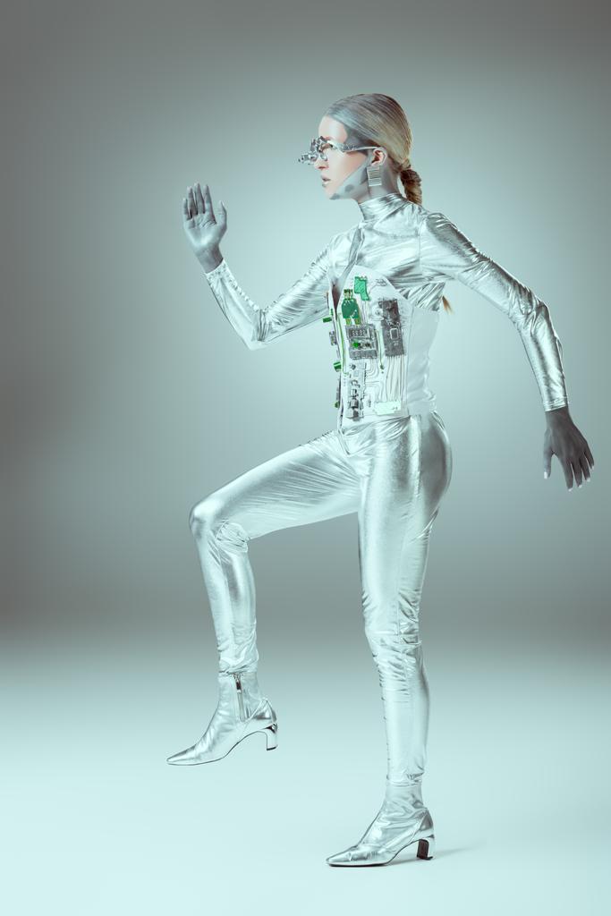 side view of futuristic cyborg walking on grey, future technology concept    - Photo, Image