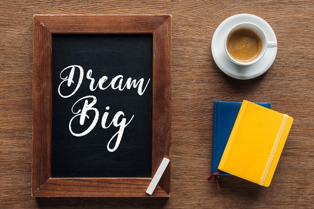 top view of chalk board with 'dream big' lettering on wooden background - Photo, Image