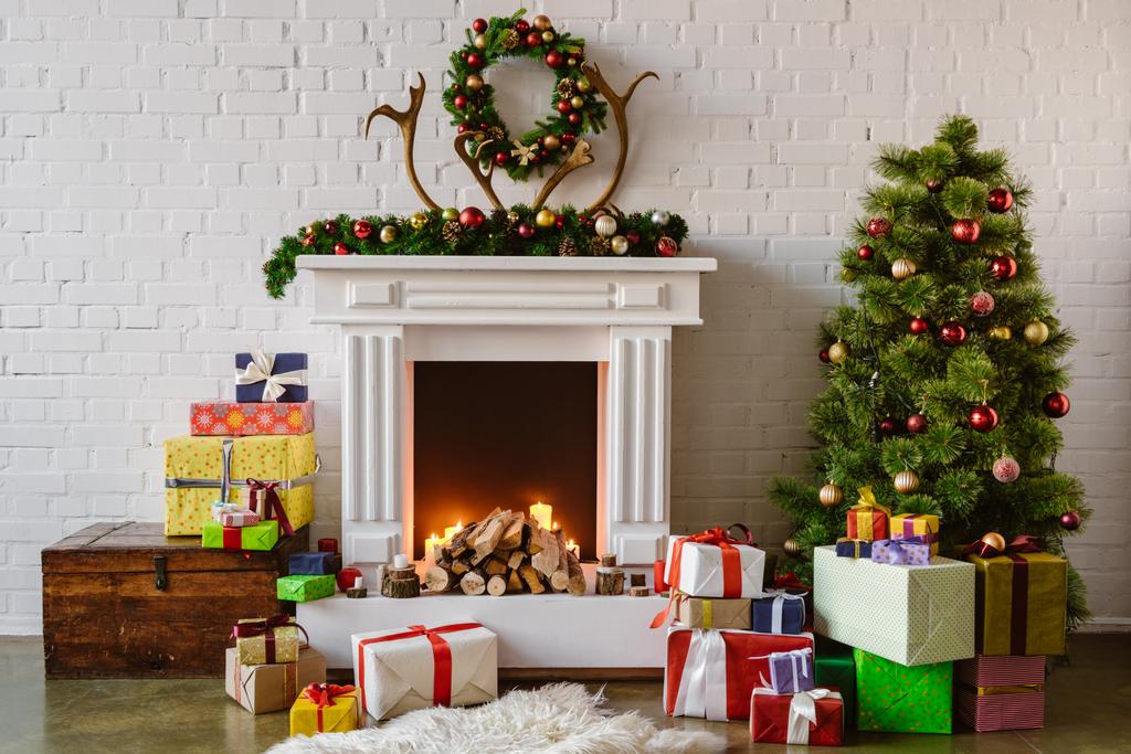 festive living room with cozy fireplace, christmas tree and presents - Photo, Image