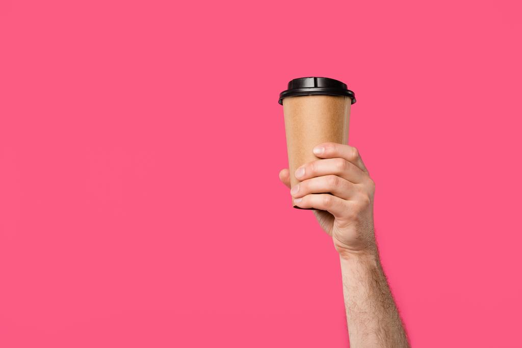 cropped shot of man holding disposable coffee cup isolated on pink - Photo, Image