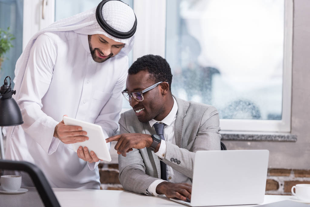 Multicultural businessmen using digital tablet in modern office  - Photo, Image