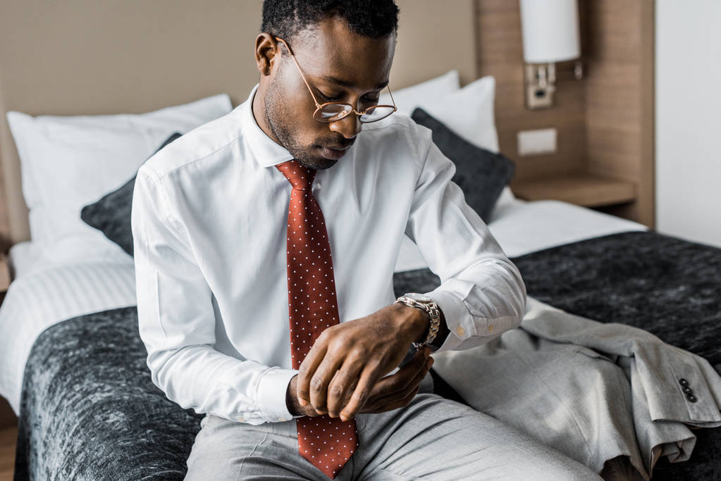 елегантний бізнесмен у формальному носінні та червоній краватці у наручних годинниках
   - Фото, зображення