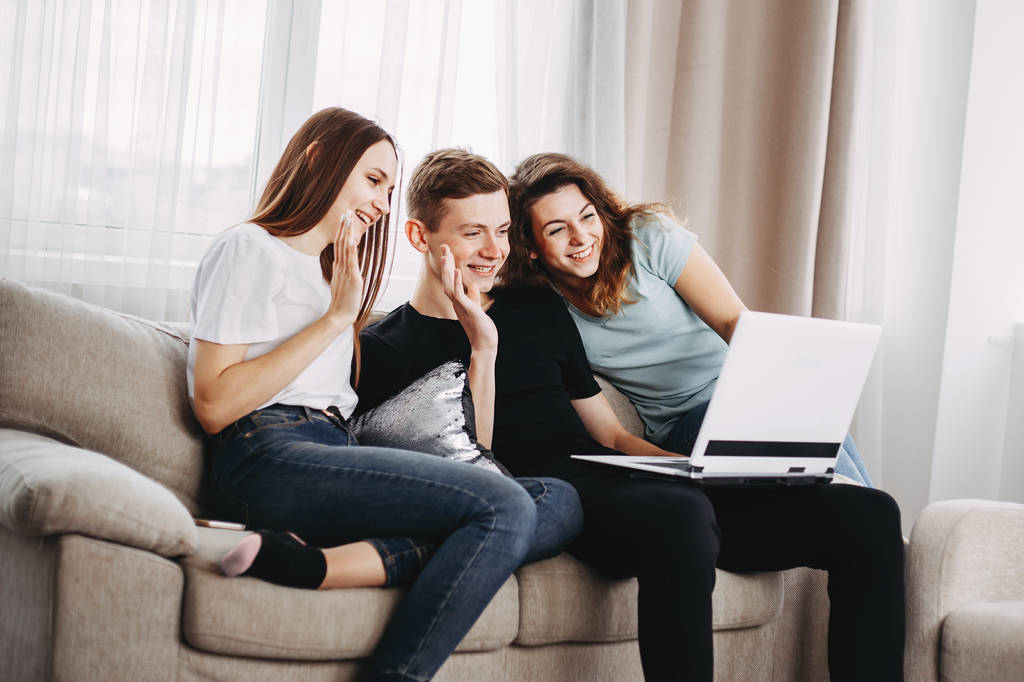 friendship, conversation, modern technology, chatting. group of young people waving to their  friends during video call using laptop - Photo, Image