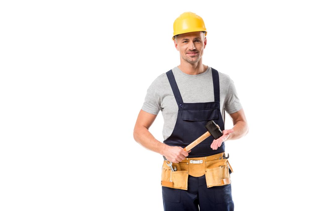 construction worker in helmet looking at camera and holding hammer isolated on white - Photo, Image