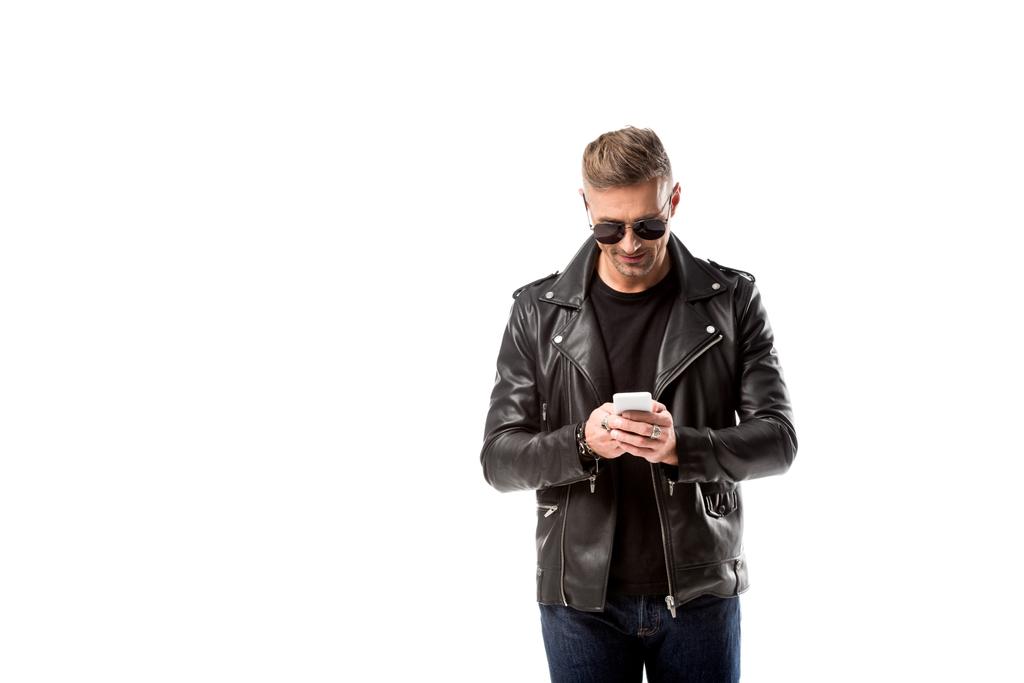 stilvoller erwachsener Mann in Lederjacke mit Smartphone isoliert auf weiß - Foto, Bild