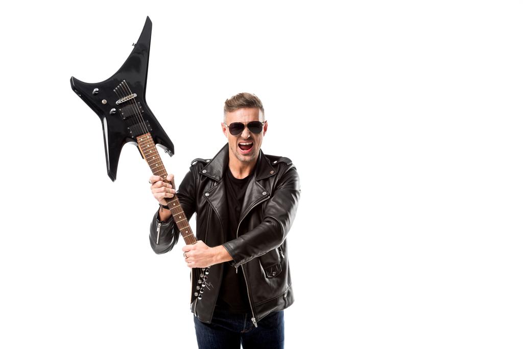 excited adult man in leather jacket holding electric guitar isolated on white - Photo, Image