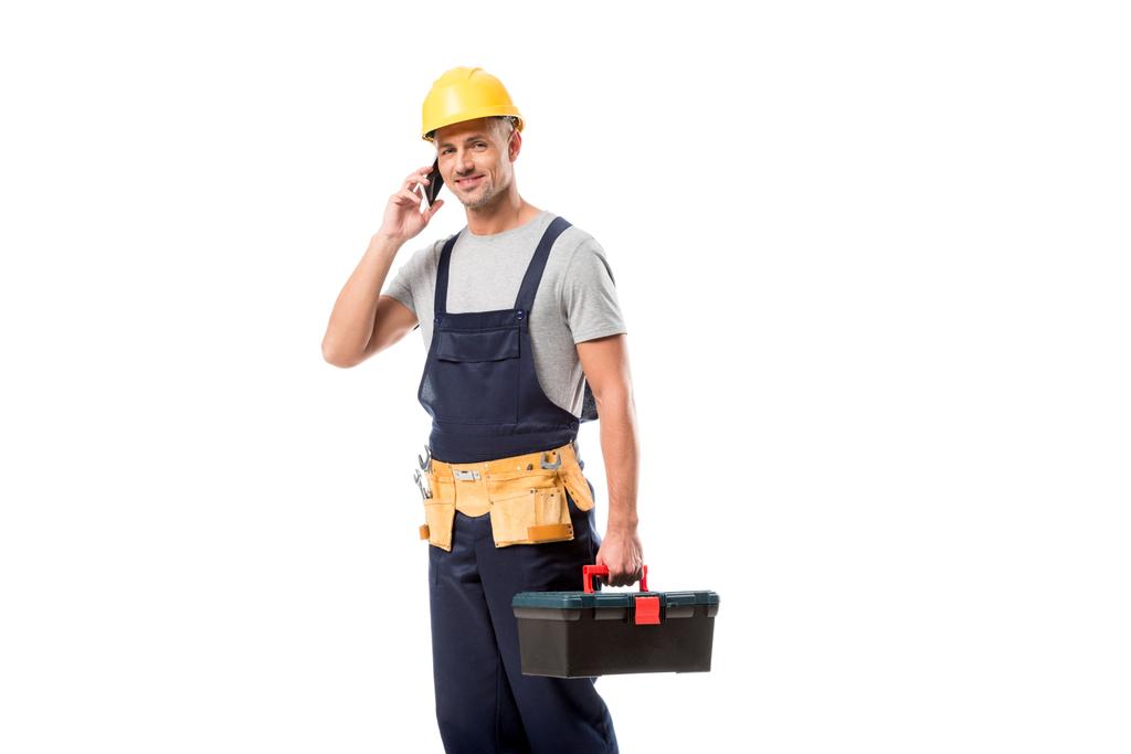 stavební dělník v přilbě na smartphone izolované na bílém - Fotografie, Obrázek