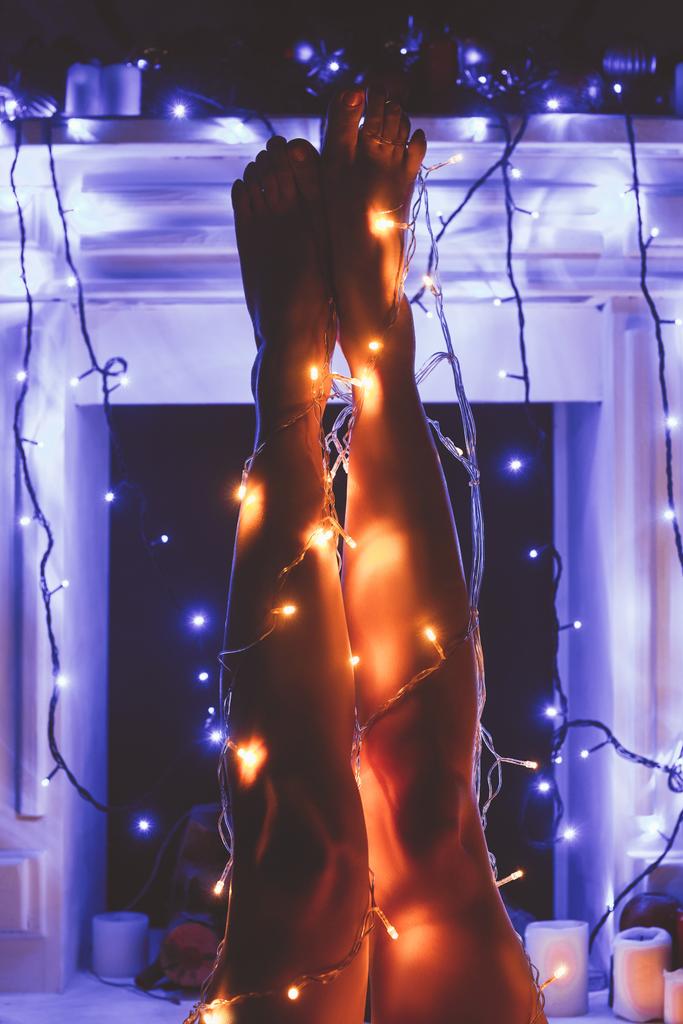 partial view of woman with christmas festive lights around - Photo, Image