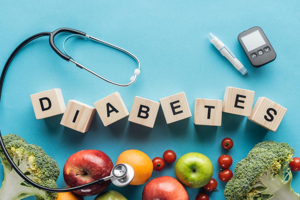"diabetes "kirjoitus puisista kuutioista lääketieteellisillä laitteilla ja hedelmillä sinisellä pohjalla
 - Valokuva, kuva