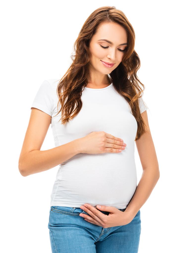 mooie lachende zwangere vrouw aanraken van de buik geïsoleerd op wit - Foto, afbeelding