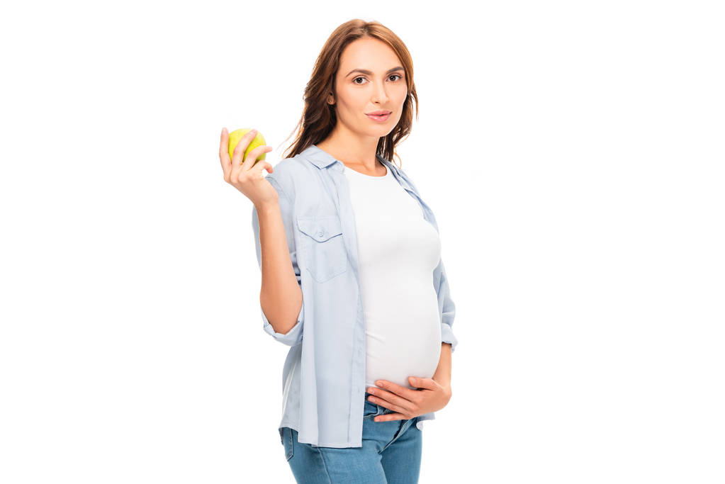 mooie gezonde zwangere vrouw houden van groene appel geïsoleerd op wit - Foto, afbeelding
