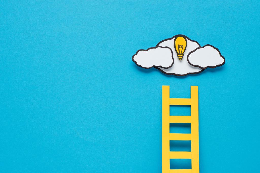 cardboard ladder, light bulb and clouds with copy space on blue background, ideas concept - Photo, Image
