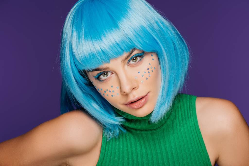 attractive glamor girl with blue wig and stars on face, isolated on purple - Photo, Image