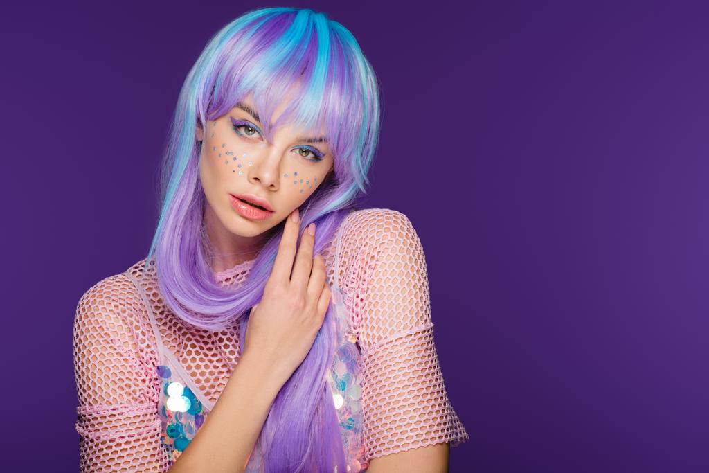 hermosa mujer de moda posando en peluca violeta con estrellas en la cara, aislado en púrpura
 - Foto, Imagen