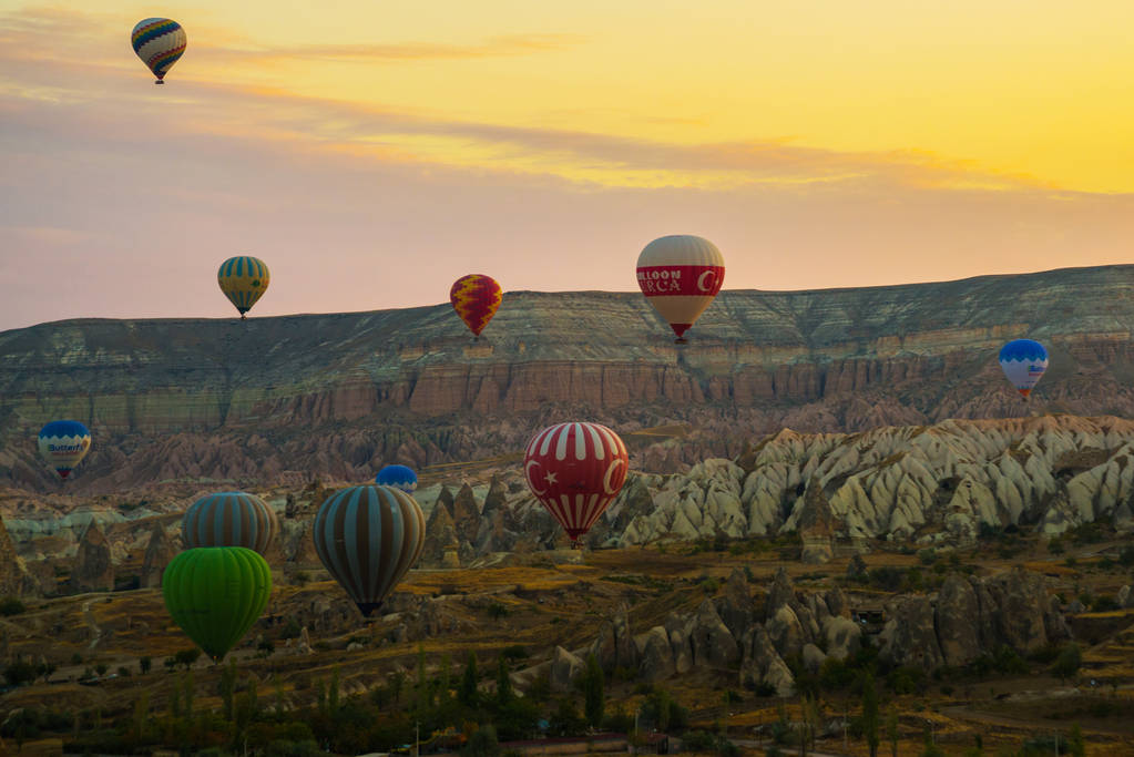 Flying on the balloons early morning in Cappadocia. Colorful sunrise in valley, Goreme village location, Turkey, Asia. Artistic style post processed photo. - Photo, Image