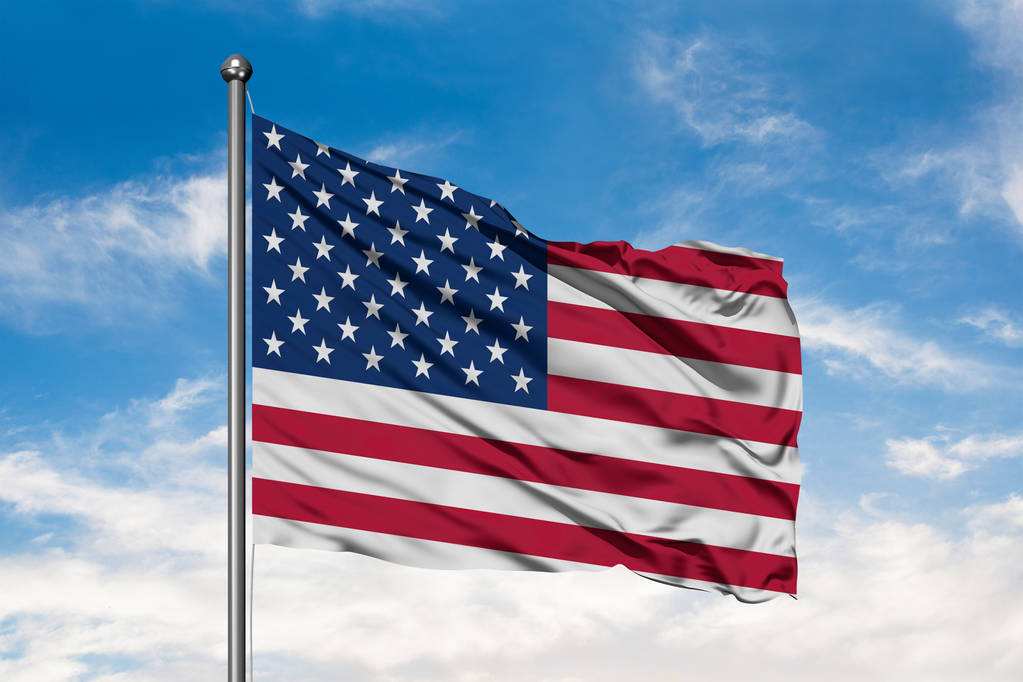 Flag of United States of America waving in the wind against white cloudy blue sky. USA flag. - Photo, Image