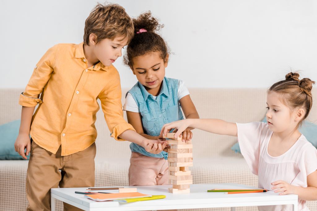 cute little multiracial children playing with wooden blocks  - Photo, Image