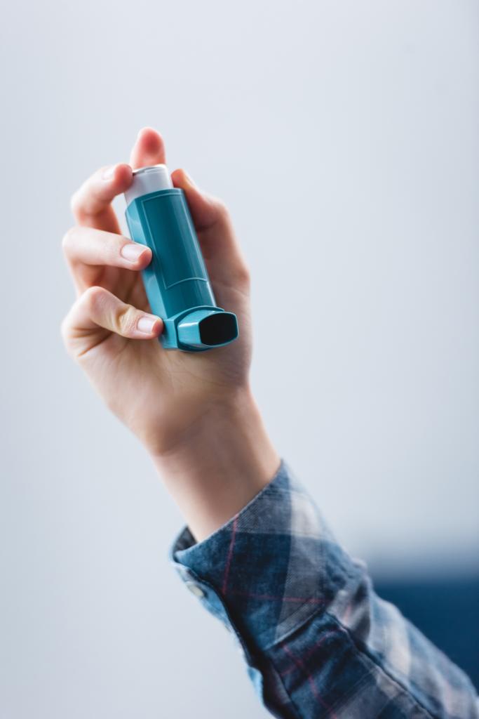 close-up partial view of young woman holding asthma inhaler - Photo, Image