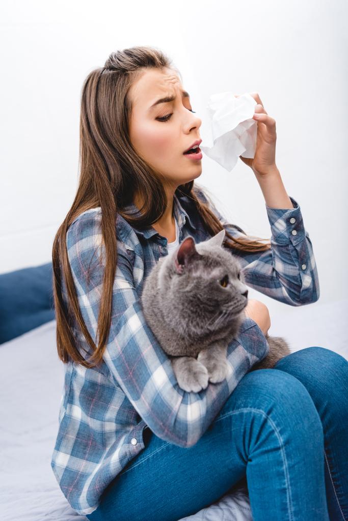 girl with allergy holding facial tissue and british shorthair cat  - Photo, Image