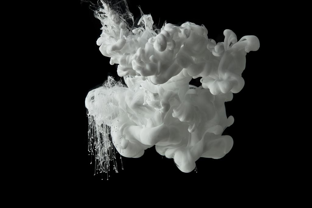 white paint swirls in water on black background - Photo, Image