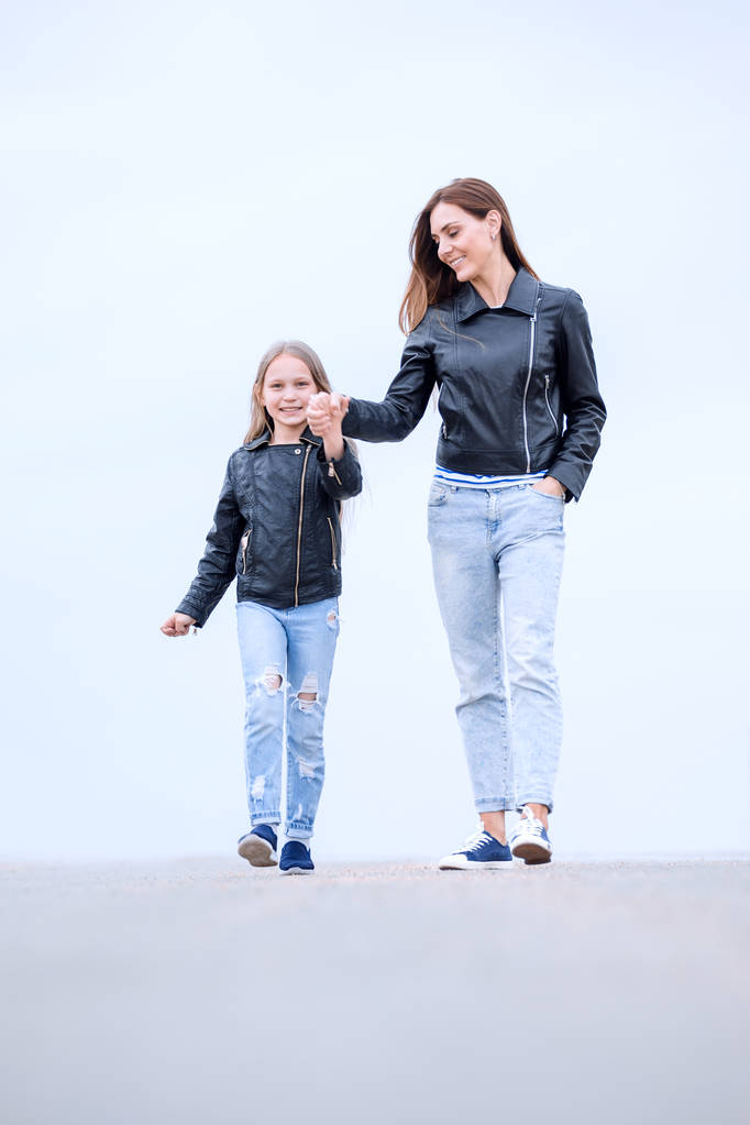 portrait of a mother and daughter walking together - Photo, Image
