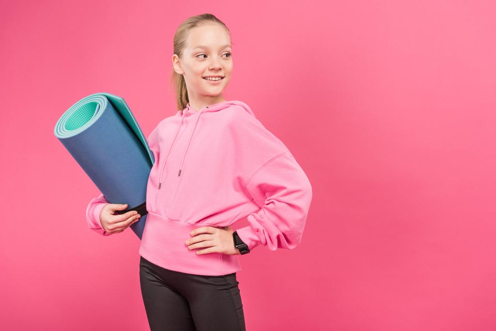 pretty female youngster holding fitness mat, isolated on pink - Photo, Image