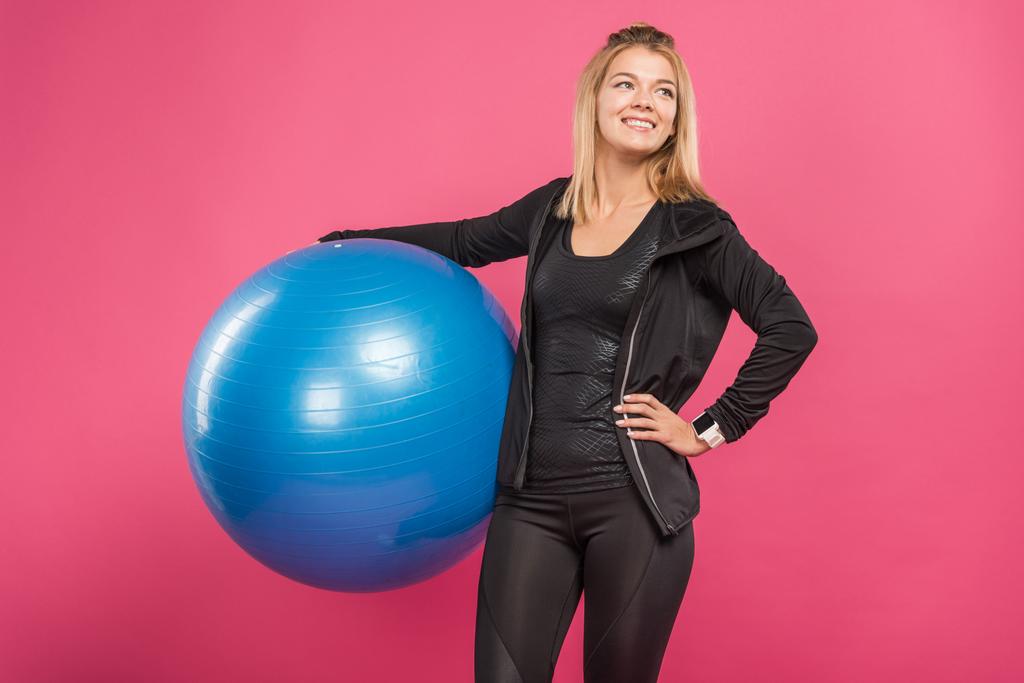 beautiful sportswoman holding fitness balls, isolated on pink - Photo, Image