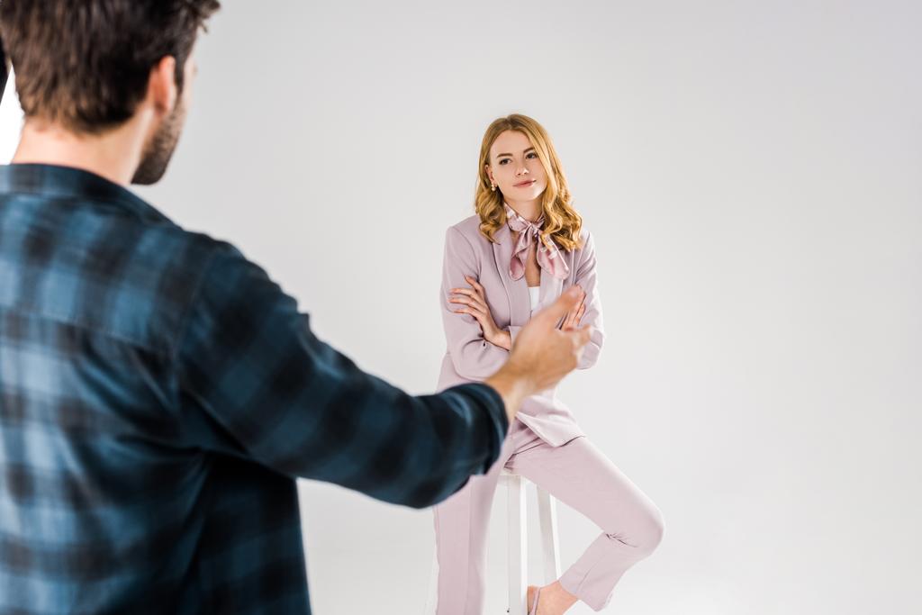 cropped shot of photographer talking with beautiful female model in studio - Photo, Image
