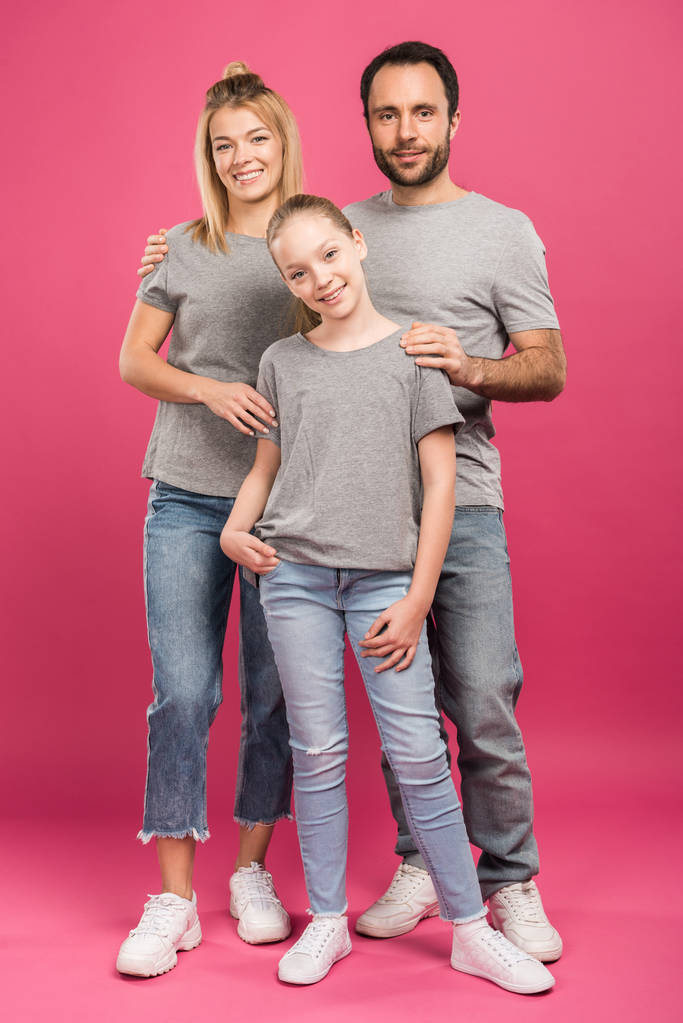 beautiful parents hugging preteen daughter, isolated on pink - Photo, Image