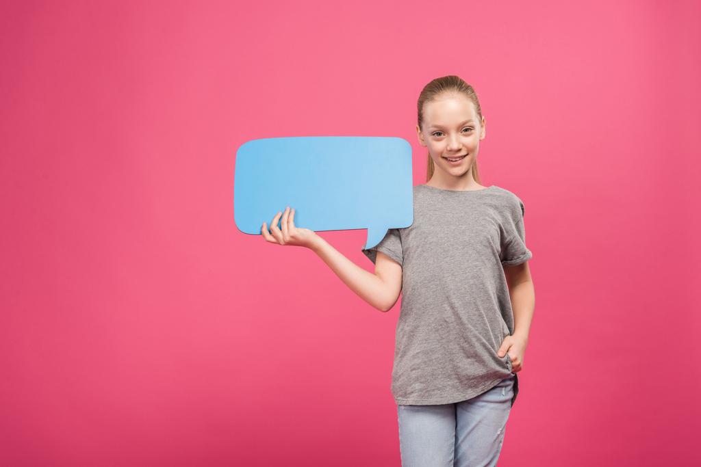 blonde youngster holding blue speech bubble, isolated on pink - Photo, Image