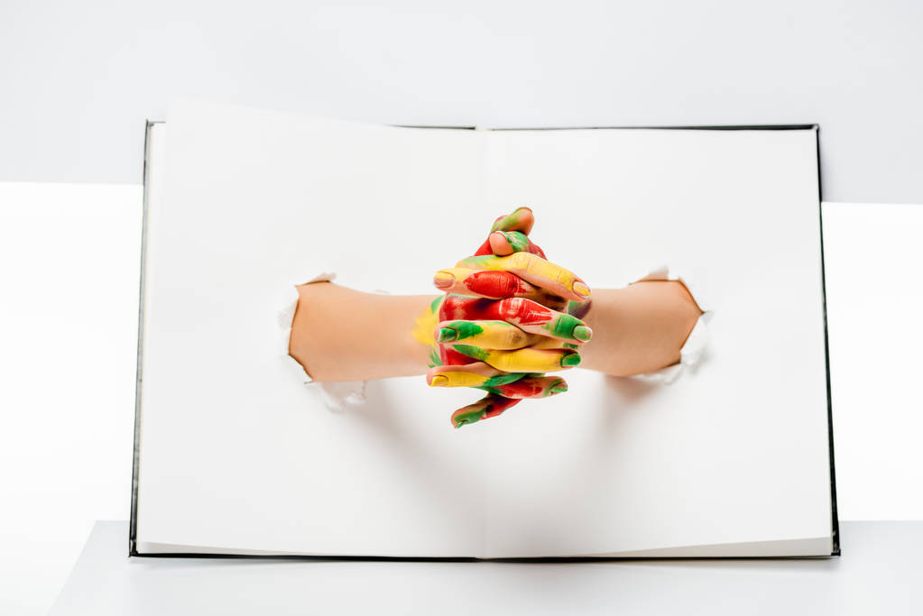 крупным планом частичный вид женских рук в краске через отверстия на белом
    - Фото, изображение