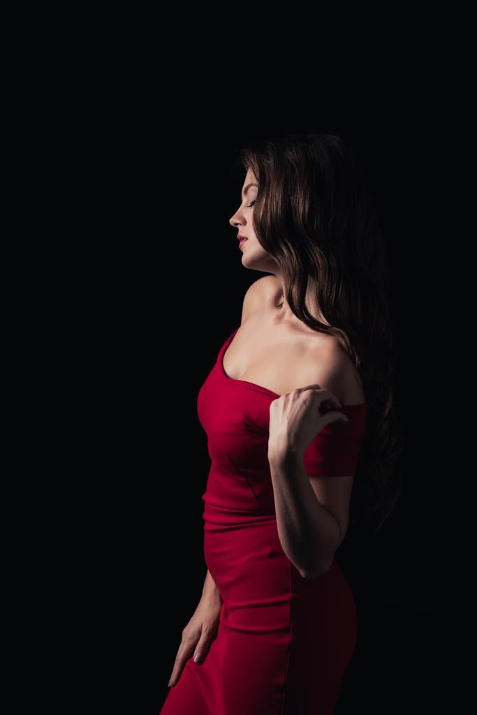 bela mulher em vestido vermelho posando isolado no preto
 - Foto, Imagem