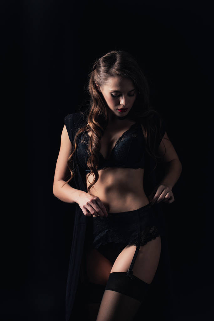 woman looking away and posing in lingerie isolated on black - Photo, Image