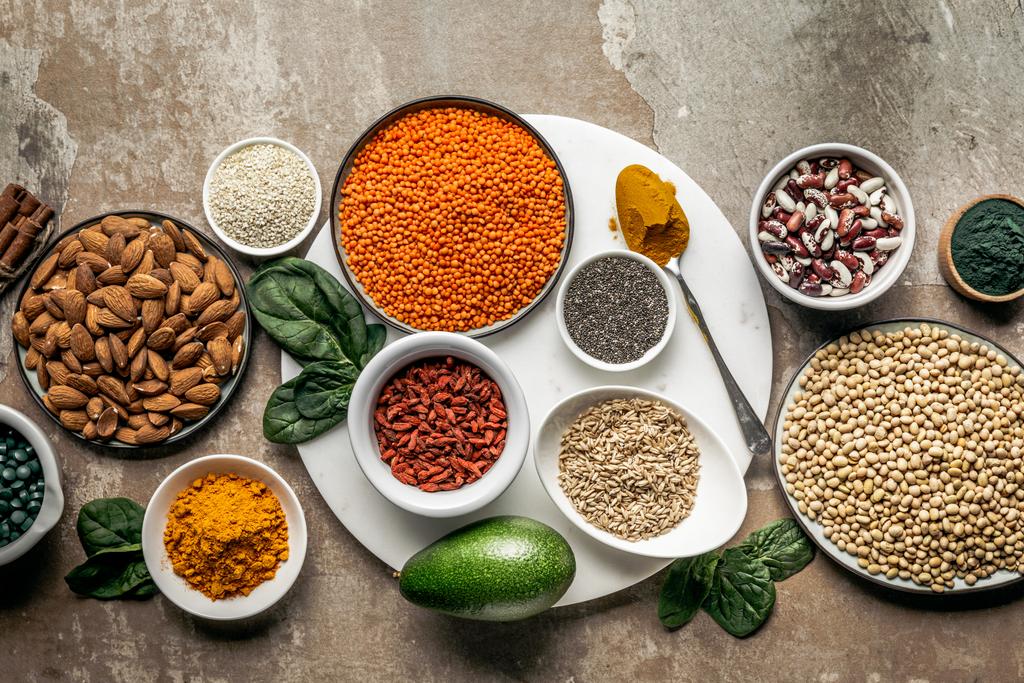 top view of superfoods, oat groats and legumes on textured rustic background - Photo, Image