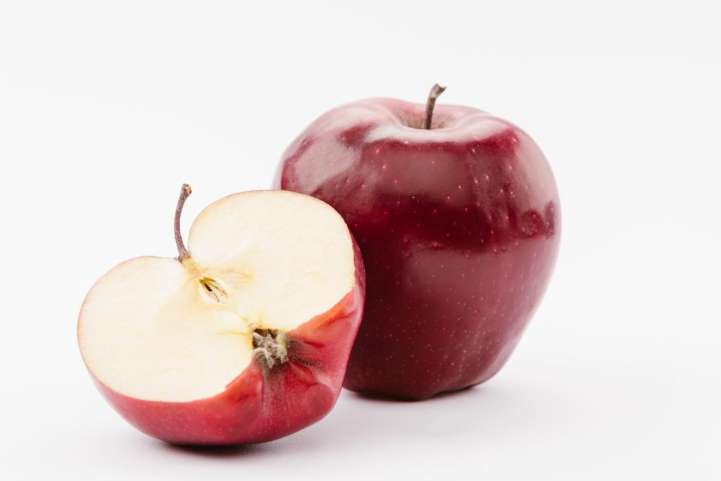 half and whole tasty red delicious apples on white background - Photo, Image