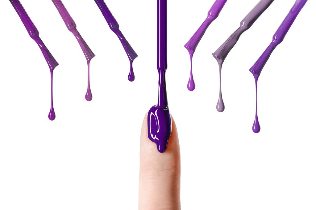 gota desordenada de esmalte de uñas púrpura brillante goteando en uñas aisladas en blanco
  - Foto, imagen