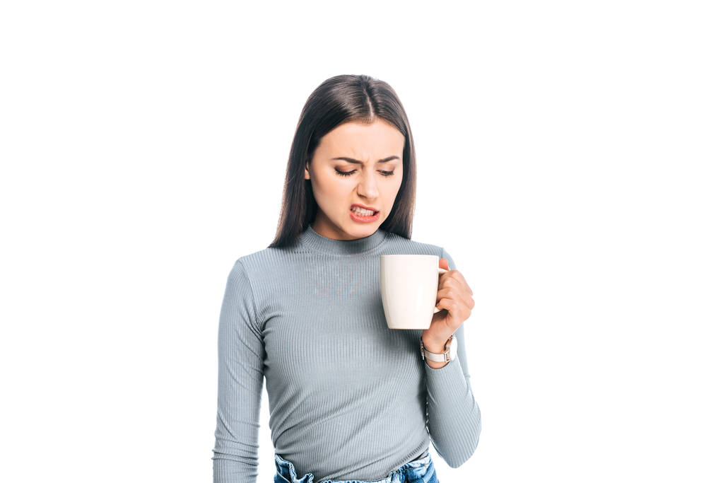 πορτρέτο της συναισθηματικής νεαρή γυναίκα με φλιτζάνι καφέ που απομονώνονται σε λευκό - Φωτογραφία, εικόνα