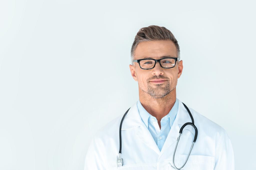 handsome doctor in glasses with stethoscope on shoulders looking at camera isolated on white - Photo, Image