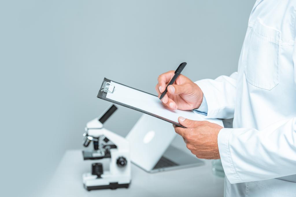 cropped image of scientist writing something at clipboard isolated on white - Photo, Image