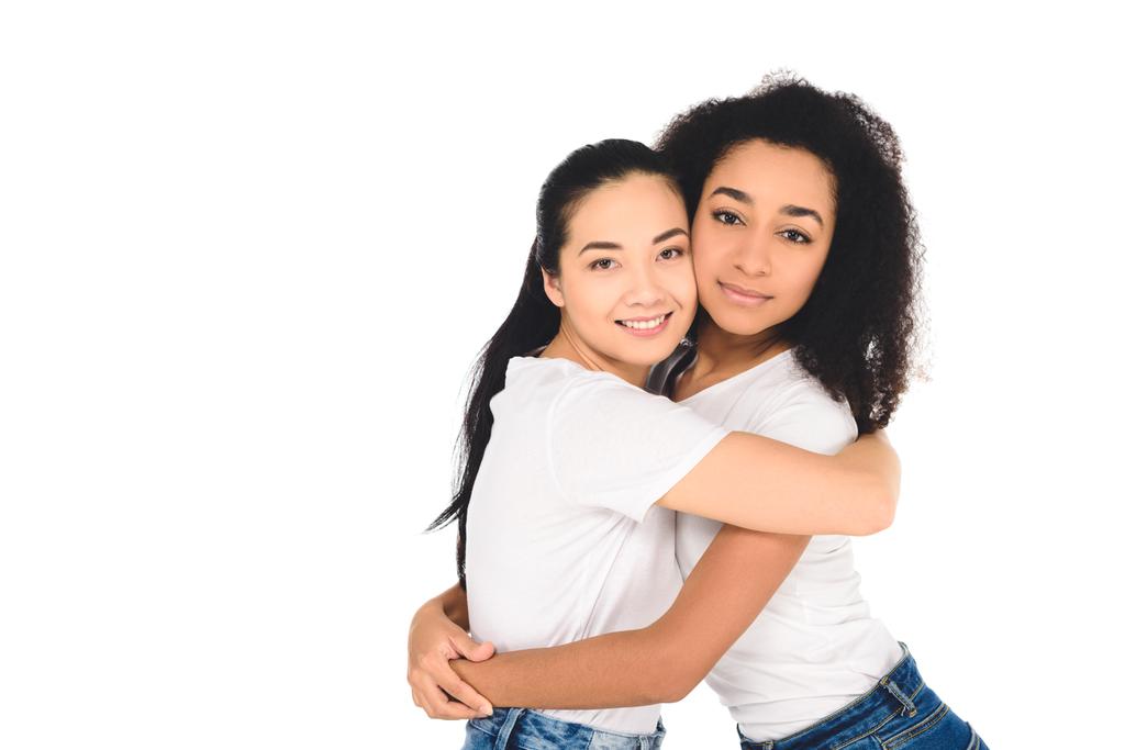multicultural friends hugging and looking at camera isolated on white - Photo, Image