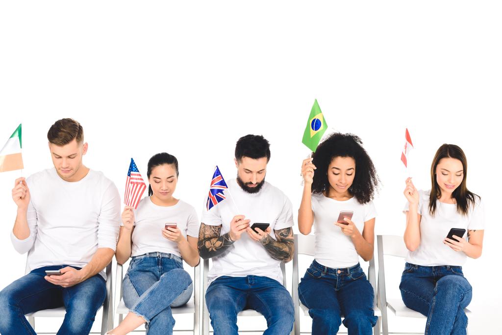 többnemzetiségű csoport fiatal használ smartphones és a gazdaság elszigetelt fehér zászlók - Fotó, kép