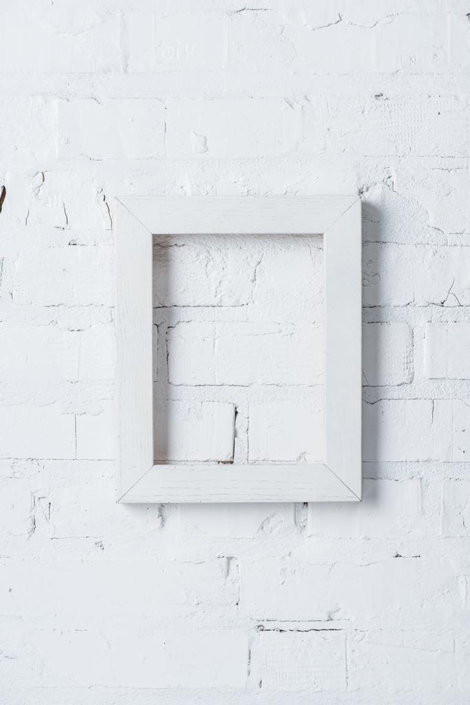 rustic frame hanging on white brick wall - Photo, Image
